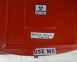 Red color bin for drip set, plastic and syringe